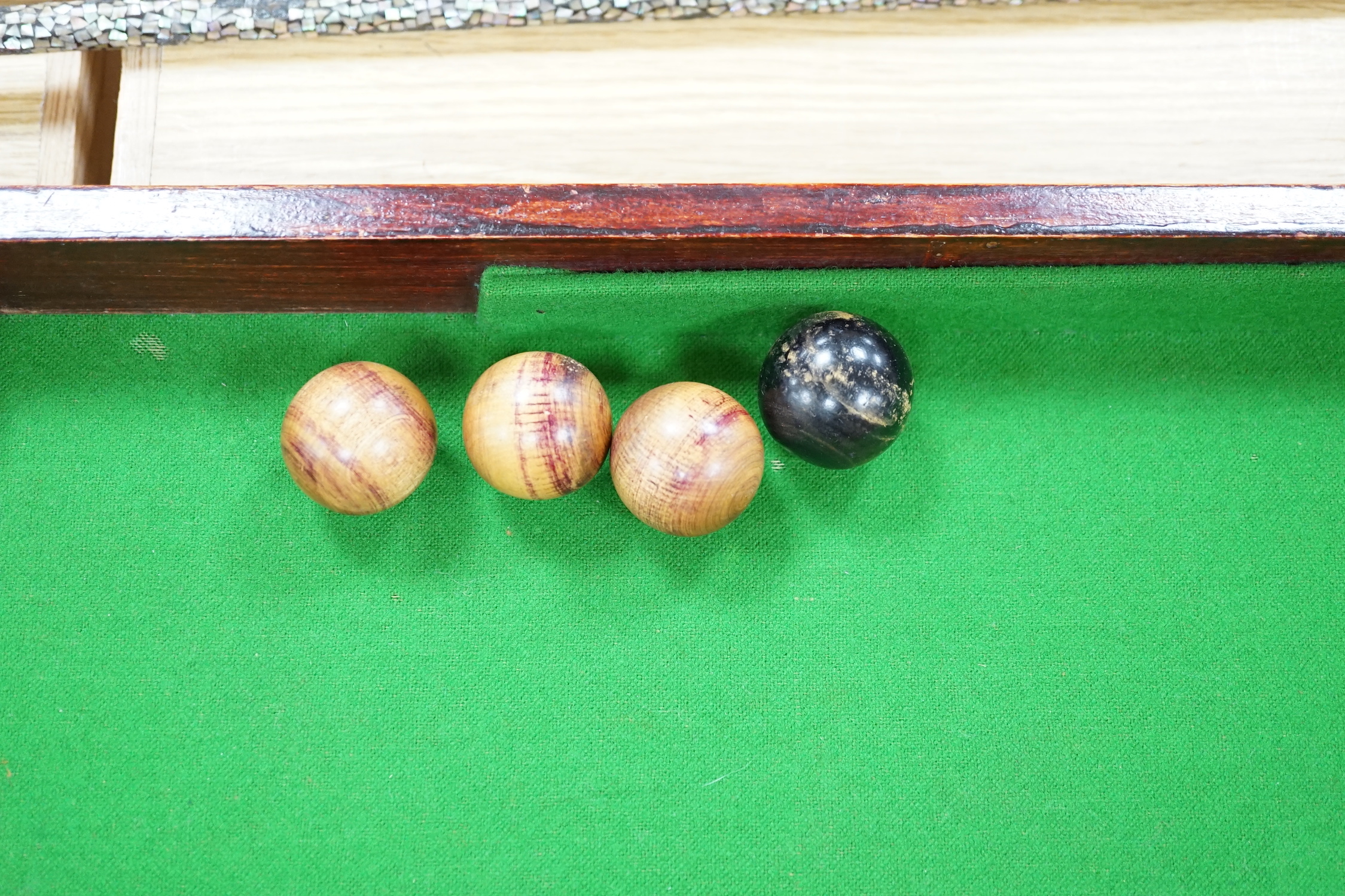 A bagatelle board, balls and cues, 108cm in length
